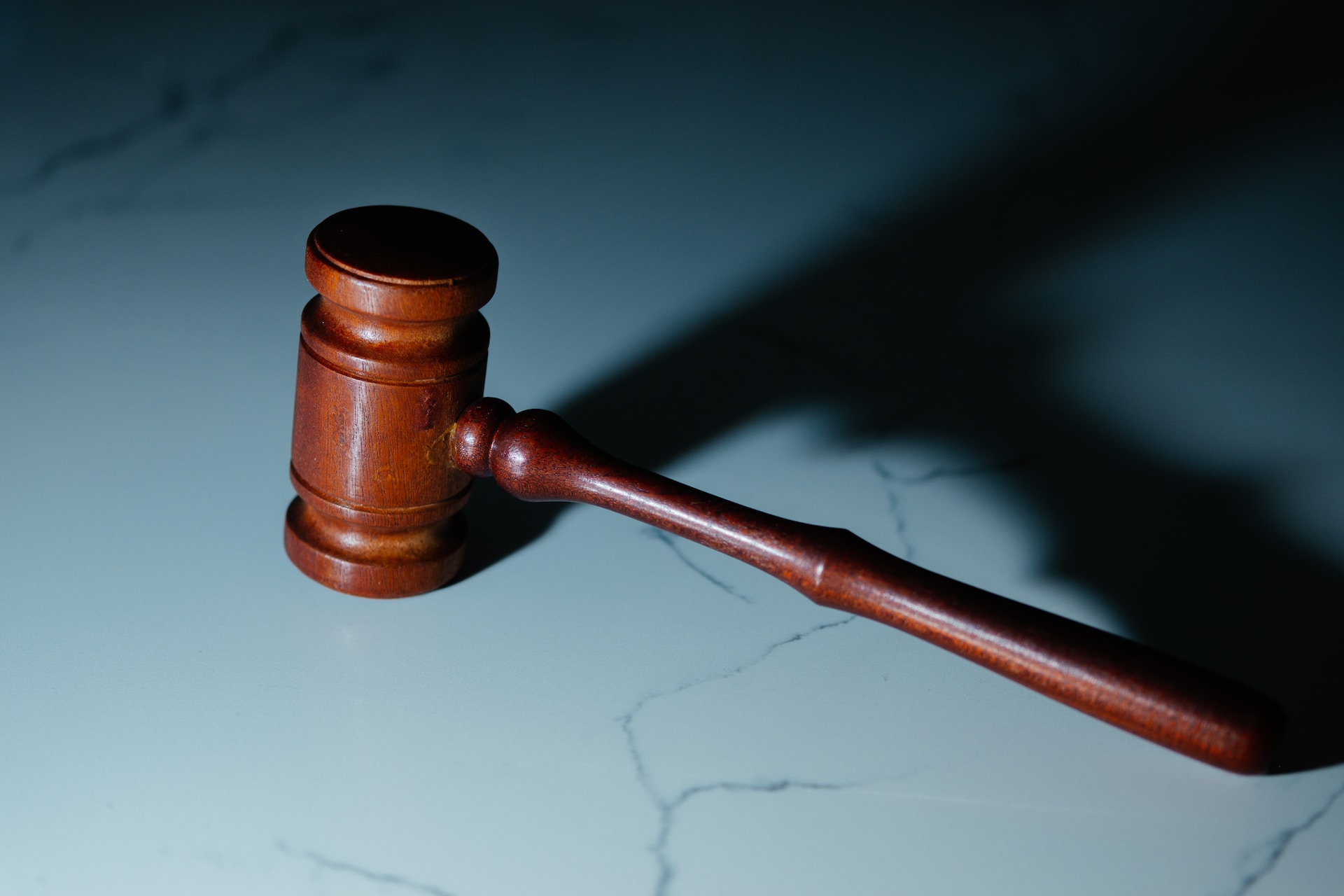 Description: Image of a wooden gavel on a marble-like surface.