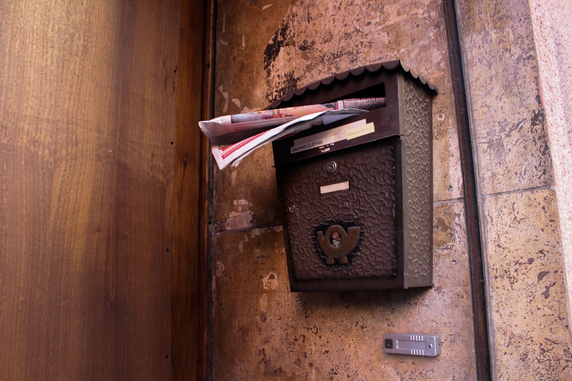 Description: a close-up image of a letterbox, overflowing with mail.