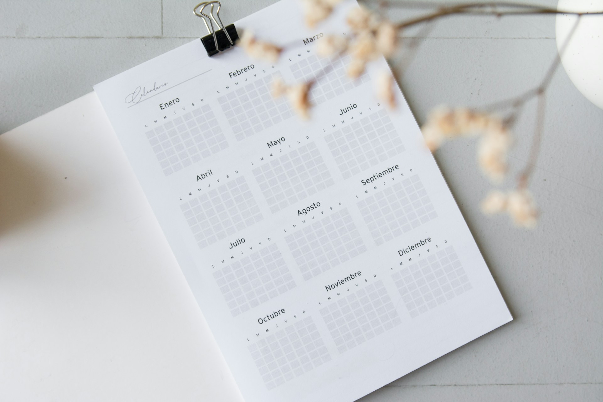 description: A printout of a one-year calendar. Photo by Paico Oficial on Unsplash.